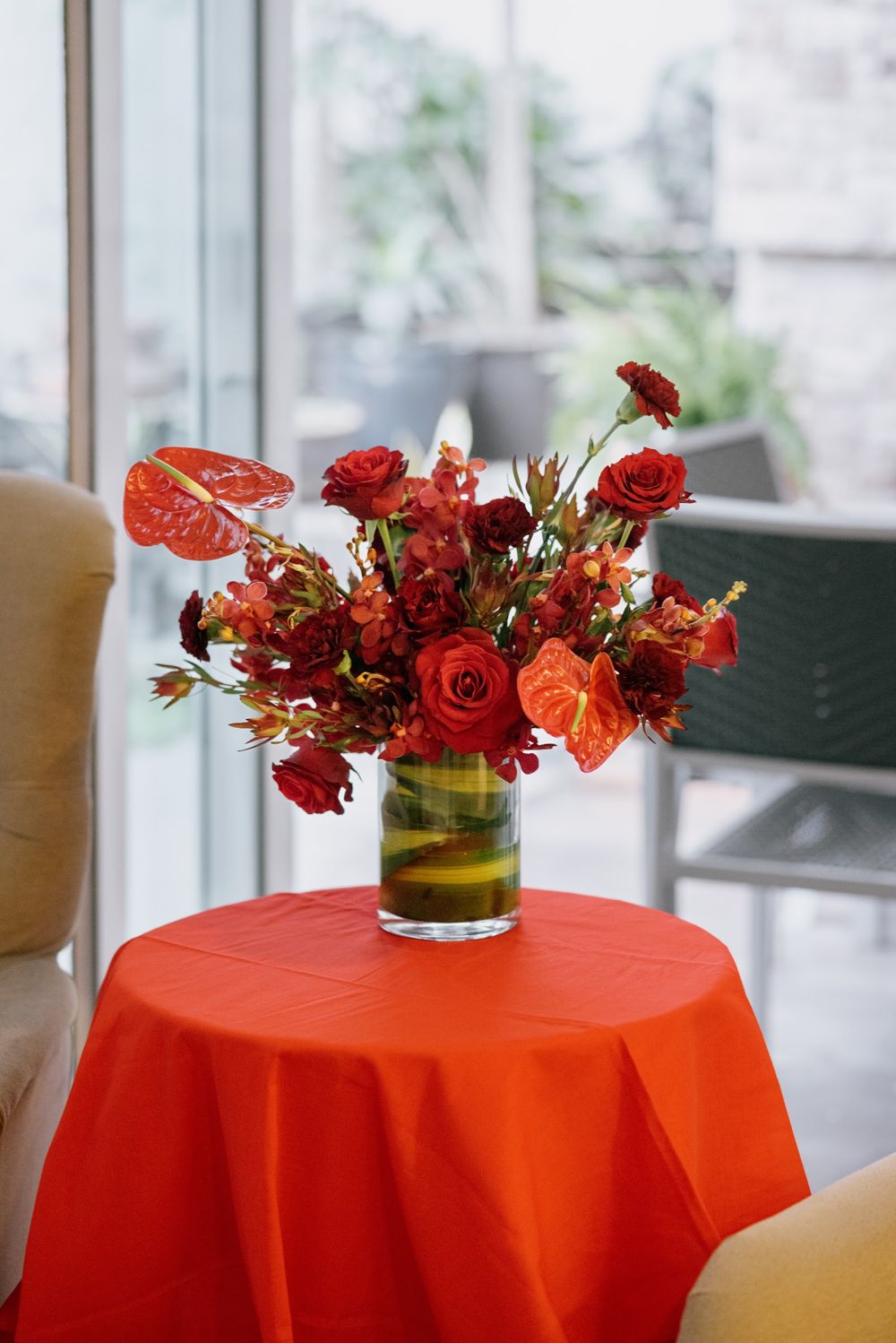 Red floral centrepiece on an orange table